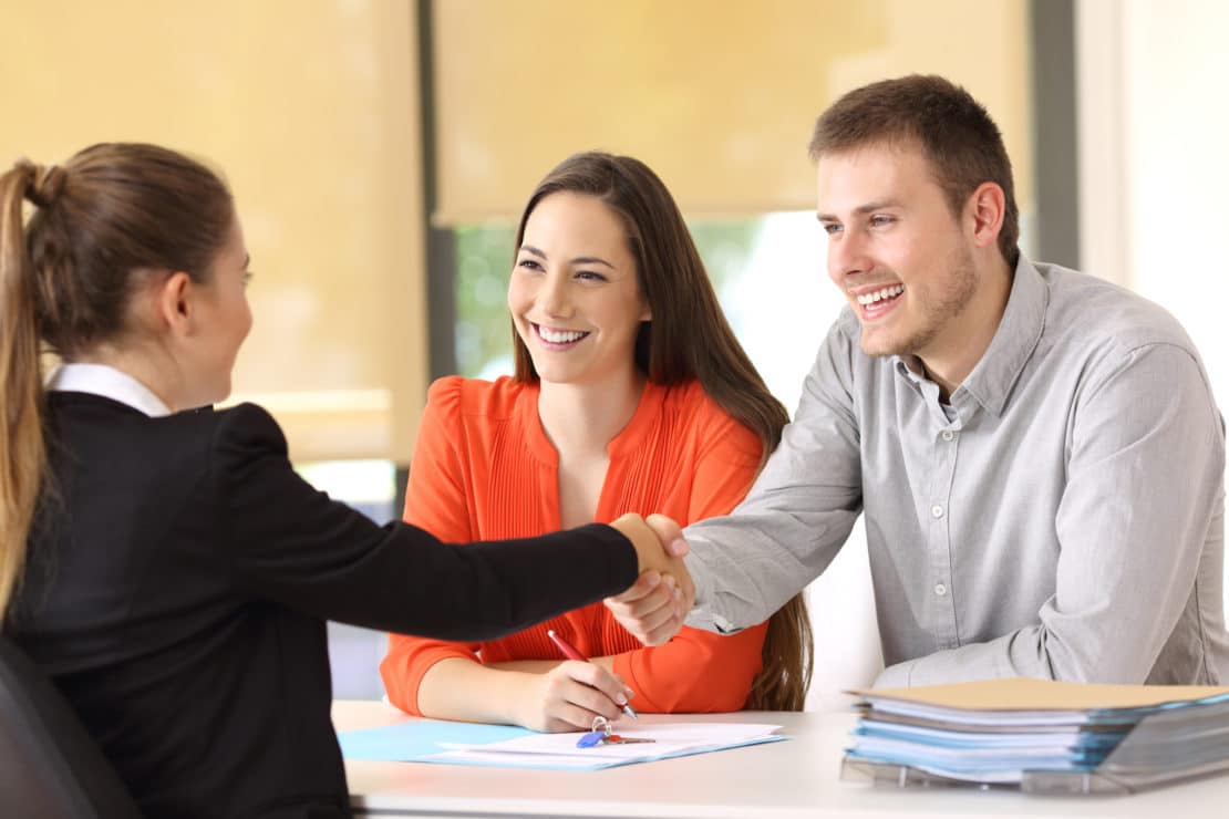Happy customers handshaking after a deal